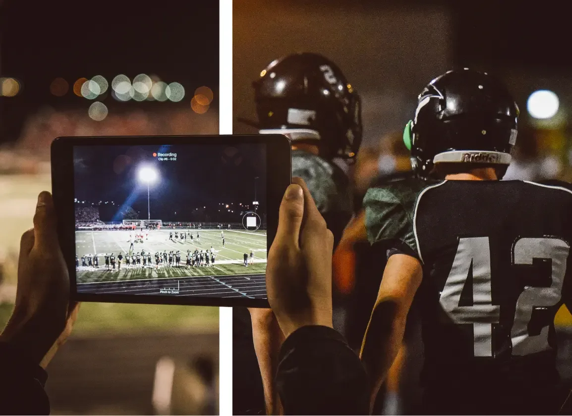 A football coach using a tablet to film from the sideline