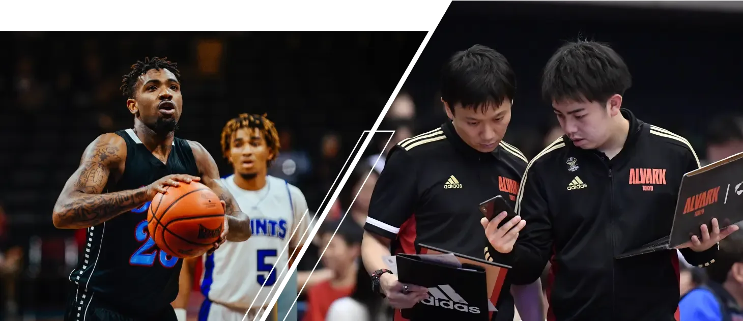 A coach is looking at a laptop displaying basketball analytics on the Hudl platform as the game is being played.