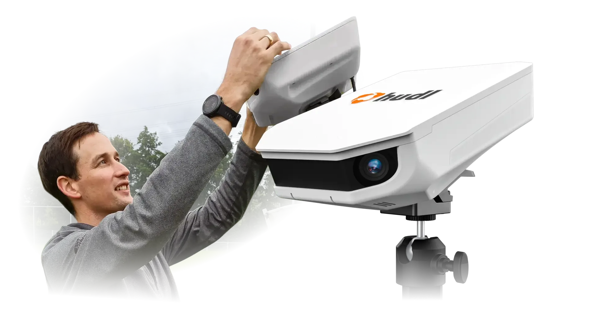 A Focus Flex camera on a tripod, next to a laptop showing a setup guide